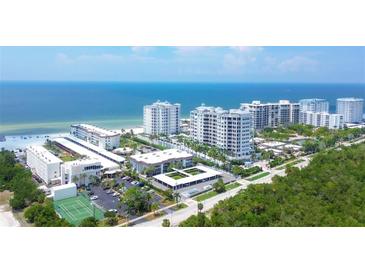 Aerial view of Lido Harbour South community, showing multiple buildings, beachfront, and tennis courts at 2110 Benjamin Franklin Dr # 108, Sarasota, FL 34236