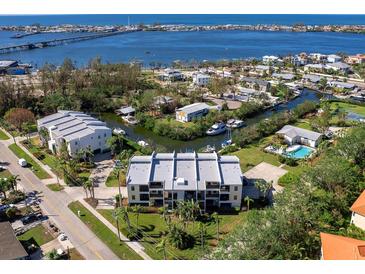 Stunning aerial view of waterfront condo community, showcasing boating access and serene surroundings at 4204 126Th W St # 506, Cortez, FL 34215