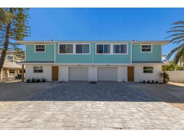 Newly constructed duplex boasts modern design, two-car garages, and attractive landscaping at 303 65Th St # A, Holmes Beach, FL 34217