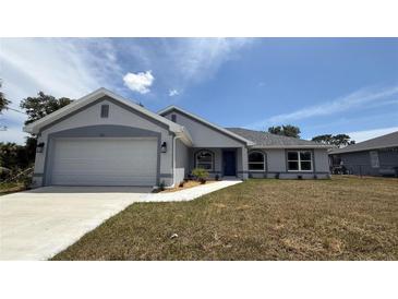 Charming single Gathering home with a well-manicured lawn and attached two-car garage at 3325 Stockton Ave, North Port, FL 34286
