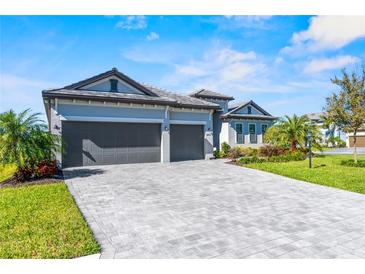 Charming single-Gathering home with a spacious three-car garage and paved driveway at 4906 Lighthouse Bay Ln, Bradenton, FL 34211
