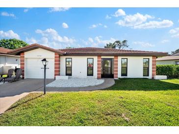 Inviting single-story home with a landscaped lawn and attached garage at 3202 60Th W Ave # 3202, Bradenton, FL 34207