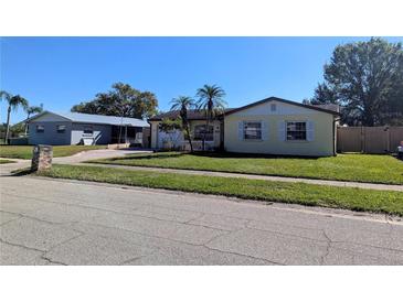 Ranch style home with a well-maintained lawn and attached garage at 3405 Highland W Ave, Bradenton, FL 34205