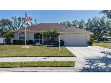 One-story home with a two-car garage, well-maintained lawn and American flag at 4569 35Th Avenue E Cir, Palmetto, FL 34221