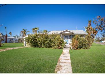 Single story home with a grassy yard and walkway at 11907 45Th W Ave, Cortez, FL 34215