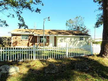 Brick and Beige Front Exterior of Ranch Style Home with White Picket Fence at 503 59Th Avenue W Dr, Bradenton, FL 34207