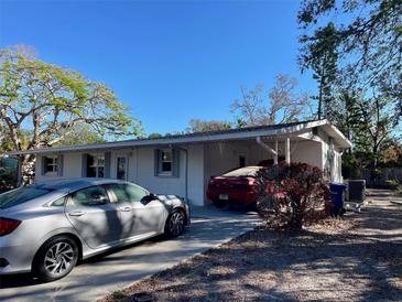 White single story home with carport and a gray car parked in driveway at 5443 Avenida Del Mare, Sarasota, FL 34242