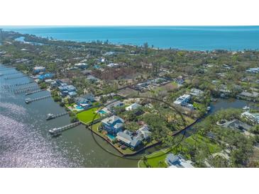 Aerial view of waterfront property with large home and private dock at 1249 S Basin Ln, Sarasota, FL 34242