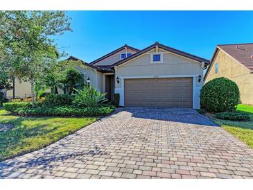 Single-story home with a brick paver driveway and landscaping at 16920 Pelham Pl, Bradenton, FL 34202