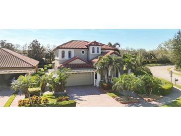 Two-story house with tile roof, landscaping, and a two-car garage at 3706 80Th E Dr, Sarasota, FL 34243