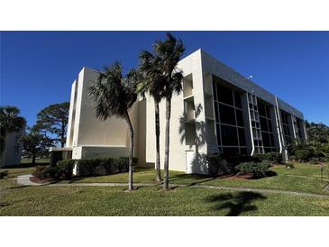 Modern condo building with palm trees and well-maintained landscaping at 4119 61St Avenue W Ter # 308, Bradenton, FL 34210