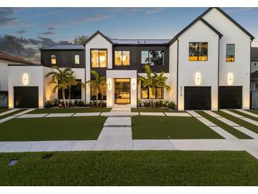 Stunning two-story home with a modern design, featuring a white brick facade and black accents at 4213 W Culbreath Ave, Tampa, FL 33609