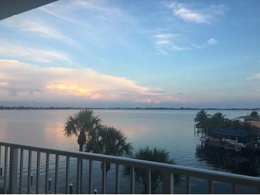 Stunning water view from private balcony, showcasing serene sunset over calm waters at 9923 Manatee W Ave # 4, Bradenton, FL 34209