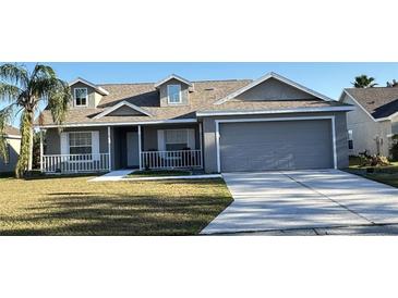 Gray two-story house with a two-car garage and a porch at 4042 Kingsfield Dr, Parrish, FL 34219