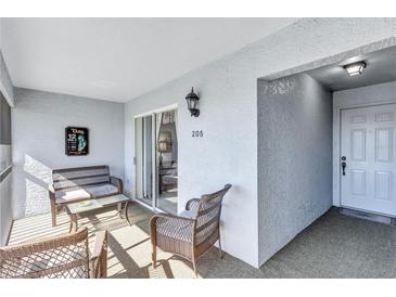 Relaxing screened porch with wicker furniture, perfect for outdoor enjoyment at 6713 Stone River Rd # 205, Bradenton, FL 34203