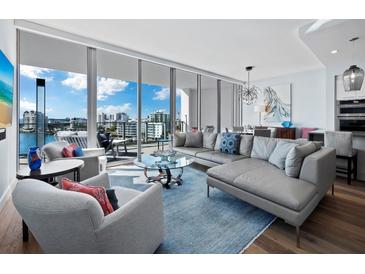 Spacious living room with water views and stylish furnishings at 1155 N Gulfstream Ave # 703, Sarasota, FL 34236