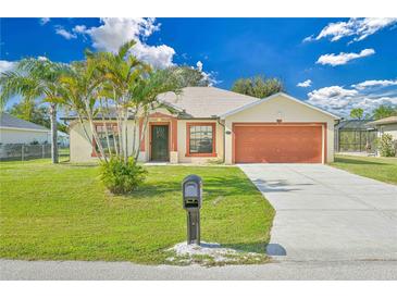 Single-story home with attached garage and landscaped lawn at 2073 Damascus Ln, Punta Gorda, FL 33983