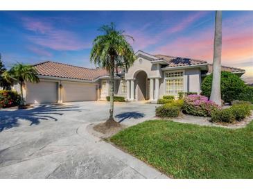 Attractive single-Gathering home with three-car garage, manicured lawn, and palm trees at 4211 Palacio Dr, Sarasota, FL 34238