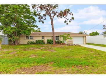 Single-story home with a spacious lawn and attached garage at 801 Church St, Nokomis, FL 34275