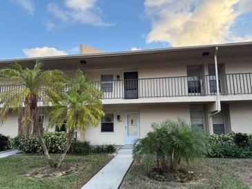 Condo building exterior featuring a walkway and landscaping at 2609 Woodgate Ln # K4, Sarasota, FL 34231