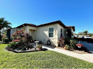 Charming single-story home featuring a well-manicured lawn and beautifully landscaped front yard with mature trees and plantings at 3306 60Th W Ave, Bradenton, FL 34207