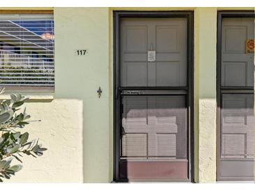 Exterior condo entrance with screen door at 6703 Midnight Pass Rd # 117, Sarasota, FL 34242