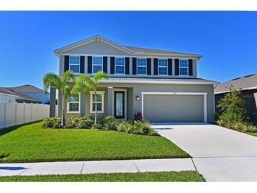 Two-story house with gray siding, black shutters, and palm trees in the front yard at 6107 116Th E Ave, Parrish, FL 34219