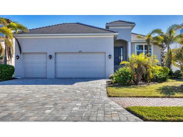 Two-car garage, paver driveway, landscaped lawn, and attractive curb appeal at 6223 Champions Row St. St, Bradenton, FL 34210