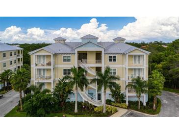 Three-story building with light-colored facade, balconies, and palm trees at 7910 34Th W Ave # 301, Bradenton, FL 34209