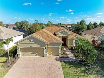 Stunning home with three-car garage, beautiful landscaping, and a well-manicured lawn at 13951 Wood Duck Cir, Lakewood Ranch, FL 34202