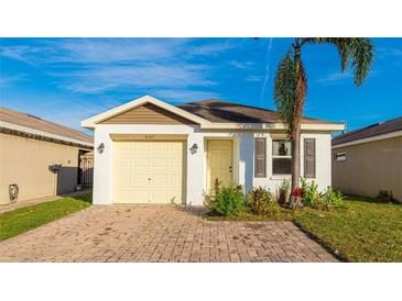 Charming single-story home features a yellow garage door, yellow front door, and a quaint front yard at 4107 11Th E St, Bradenton, FL 34208