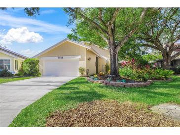 Well-maintained house with a large tree and landscaped yard at 4132 Carriage Cir # 12, Sarasota, FL 34241