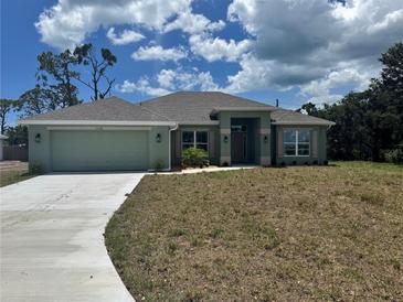 Charming single-story home featuring a two car garage and a well-manicured lawn at 5770 Englewood Rd., Venice, FL 34293