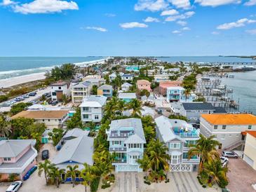 Beachfront property aerial view showcasing the home and neighborhood at 106 7Th S St, Bradenton Beach, FL 34217