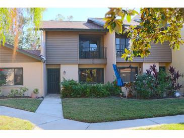 Two-story townhome with a green door and well-maintained landscaping at 976 Sunridge Dr # I6, Sarasota, FL 34234