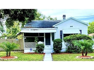 Charming one-story home featuring a screened front porch and manicured landscaping at 3642 Dartmouth N Ave, St Petersburg, FL 33713