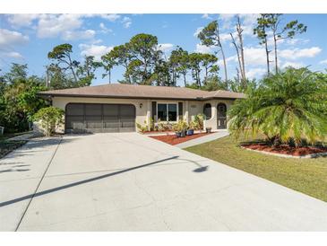 Single-story home with a two-car garage and landscaped front yard at 4239 Durant St, Port Charlotte, FL 33948