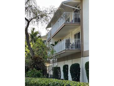 Building exterior showcasing balconies and landscaping at 1714 69Th W Ave # A207, Bradenton, FL 34207