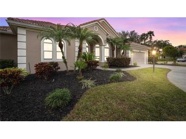 Well-maintained house with manicured lawn and palm trees at 7042 Twin Hills Ter, Lakewood Ranch, FL 34202