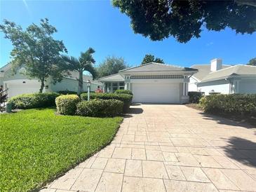 Single-story home with attached garage and well-manicured lawn at 321 Lansbrook Dr, Venice, FL 34292