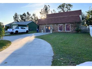 Charming exterior elevation with brick facade and mature landscaping at 5630 3Rd W St, Bradenton, FL 34207