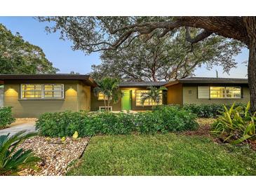 Charming ranch home with landscaped yard and a bright green front door at 2674 Jefferson Cir, Sarasota, FL 34239