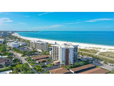 Aerial view of beachfront condo building with ocean and beach views at 101 Benjamin Franklin Dr # 54, Sarasota, FL 34236
