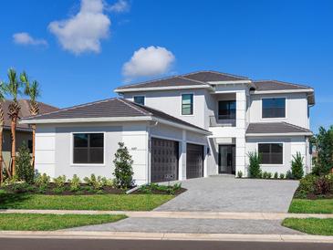 Two-story home with gray exterior, three-car garage, and landscaped yard at 4689 Cedron Ct, Sarasota, FL 34240