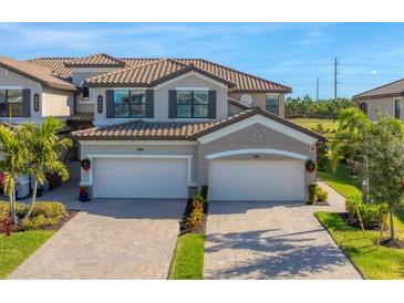 Two-story house with two-car garage, and nicely landscaped lawn at 6035 Worsham Ln # 104, Lakewood Ranch, FL 34211