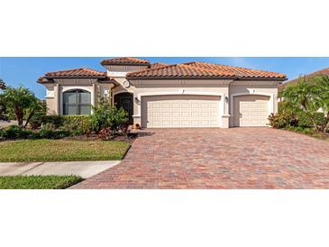 Beautiful one-story home with three-car garage and a brick paved driveway at 6849 Wild Lake Ter, Bradenton, FL 34212