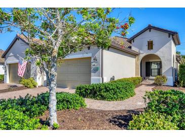 Charming single-story home with a welcoming front entrance and landscaped yard at 11265 Mc Dermott Ct, Englewood, FL 34223