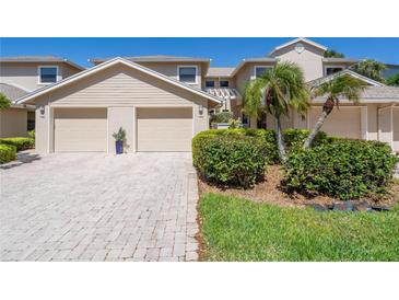 Attractive two-story townhome with a two-car garage and landscaped front yard at 1720 Starling Dr # 103, Sarasota, FL 34231