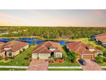 Aerial view of single-Gathering home with lake access in a tranquil community at 20720 Saluti Pl, Venice, FL 34293