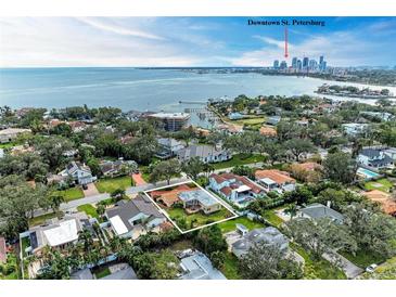 Aerial view of a single-Gathering home with a large backyard, located near the water at 124 Giralda Ne Blvd, St Petersburg, FL 33704